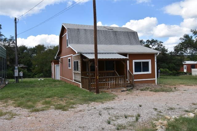 exterior space with covered porch and a garage