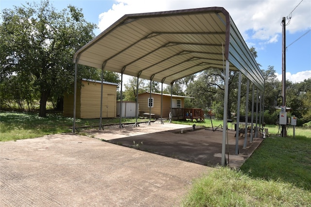 view of parking / parking lot with a lawn and a carport