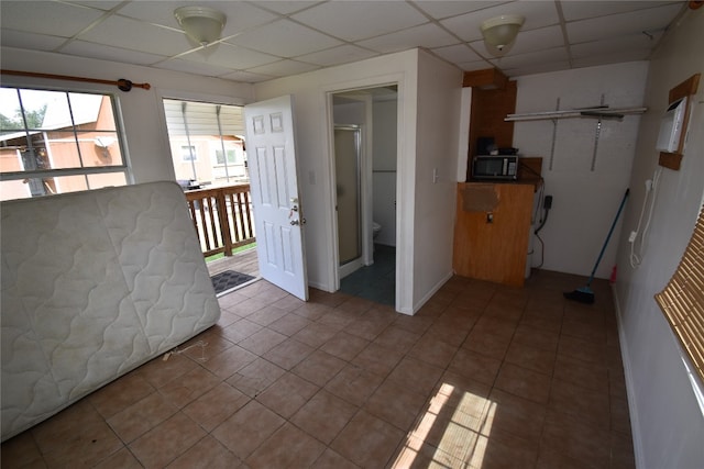 interior space featuring a drop ceiling and tile patterned floors