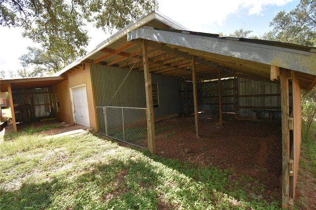 exterior space with a carport and a garage