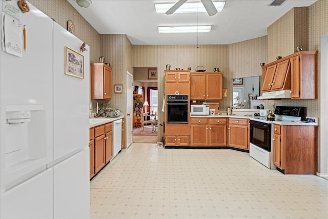 kitchen with white appliances, ceiling fan, and sink