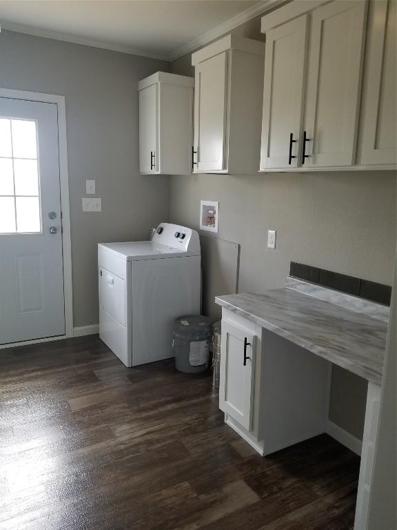 1256 Sunrise Vis, Thorndale, TX 76577 - laundry area with ornamental molding, dark wood finished floors, washer / clothes dryer, and cabinet space