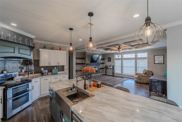 kitchen featuring light stone countertops, dark wood-type flooring, hanging light fixtures, white cabinetry, and double oven range