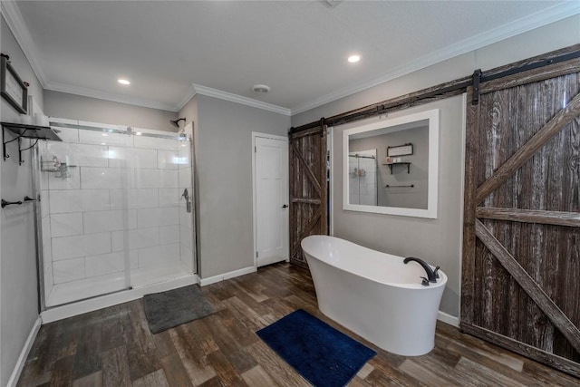 1256 Sunrise Vis, Thorndale, TX 76577 - bathroom featuring a stall shower, baseboards, recessed lighting, a freestanding tub, and wood finished floors