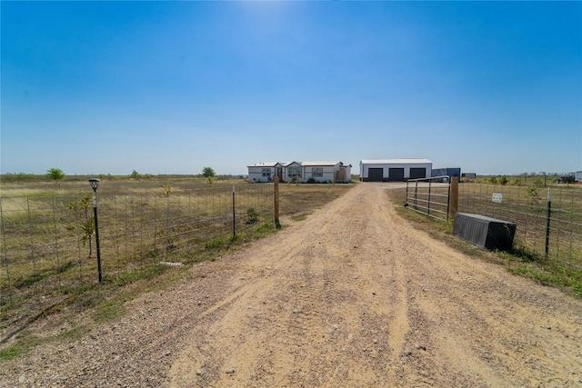 1256 Sunrise Vis, Thorndale, TX 76577 - view of street featuring a rural view, a gated entry, and driveway