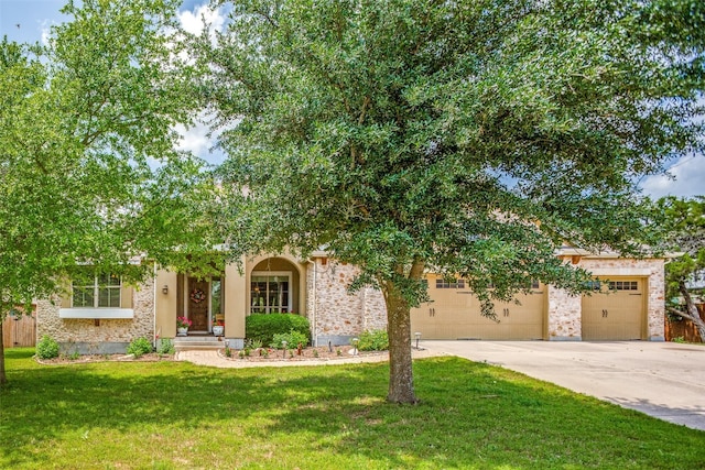 view of front of home with a garage and a front lawn