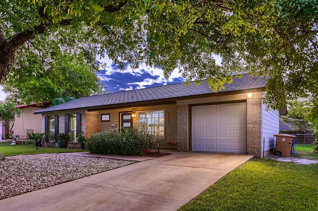 ranch-style home featuring a front yard and a garage