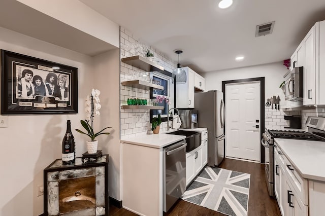 kitchen with decorative backsplash, stainless steel appliances, white cabinets, and sink