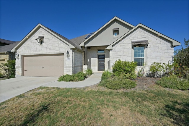 view of front of home with a front yard and a garage