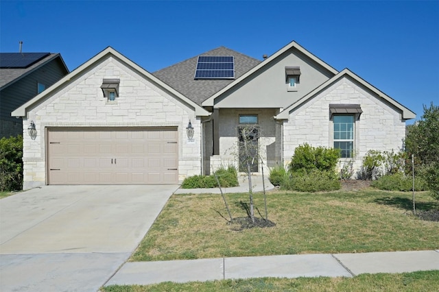 view of front of house with a garage, a front yard, and solar panels