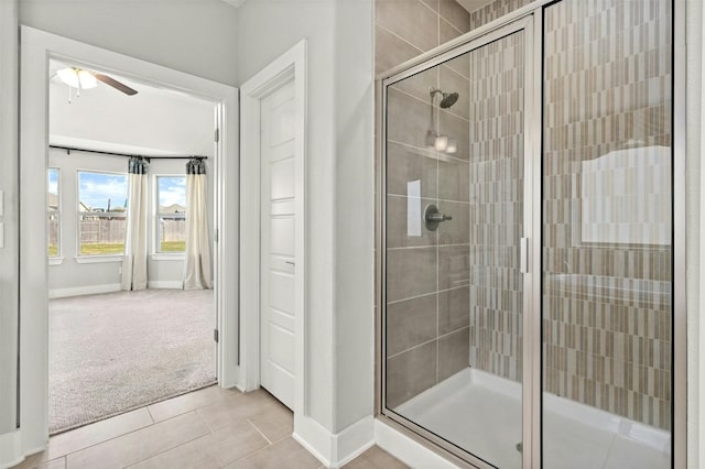 bathroom with tile patterned floors, ceiling fan, and an enclosed shower