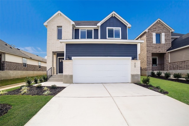 view of front of property featuring a front yard and a garage