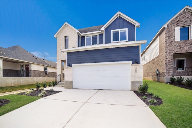 view of front of home with a front yard and a garage