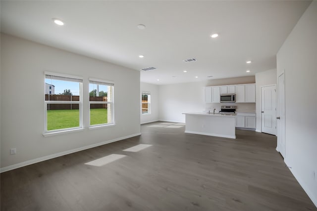 unfurnished living room featuring dark wood-type flooring