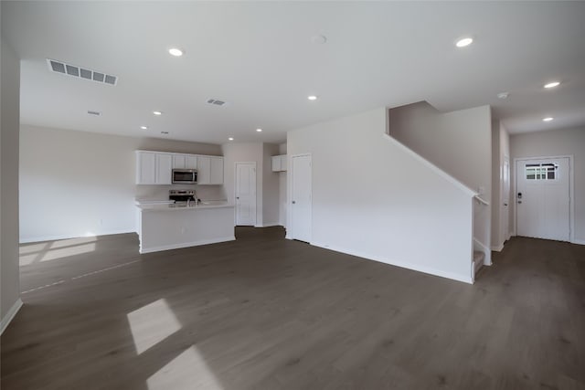 unfurnished living room featuring dark hardwood / wood-style floors