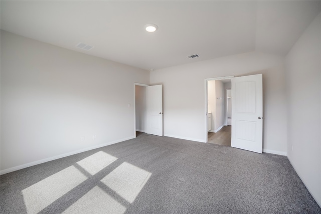 unfurnished bedroom with dark colored carpet