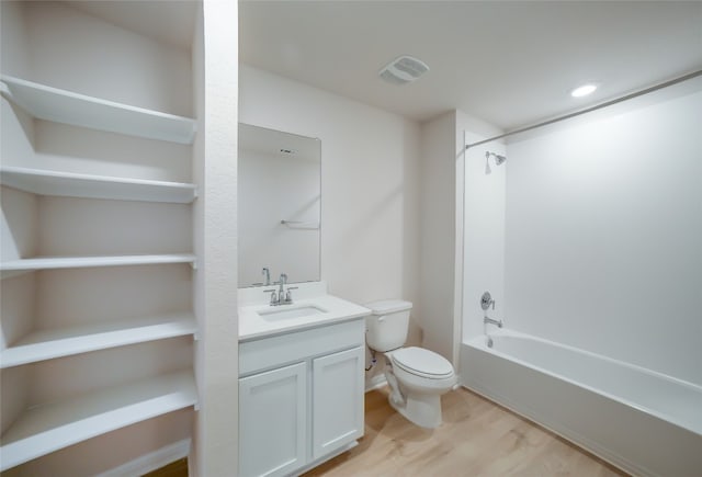 full bathroom featuring hardwood / wood-style floors, vanity, toilet, and washtub / shower combination