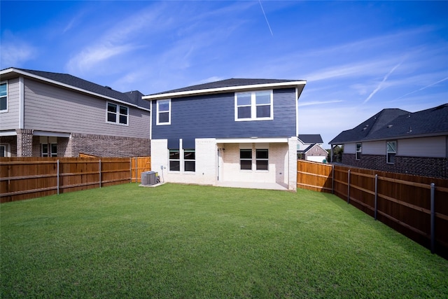 back of house with a patio, a yard, and central AC