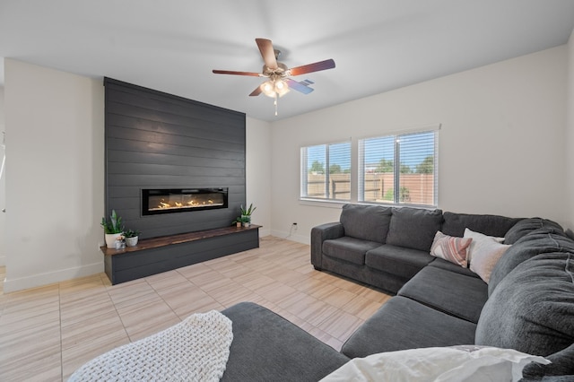 living room with a fireplace, ceiling fan, and light tile patterned floors