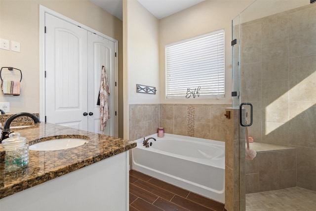 bathroom featuring independent shower and bath and vanity