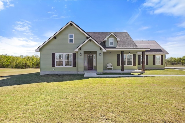 view of front facade featuring a front lawn, solar panels, and a porch