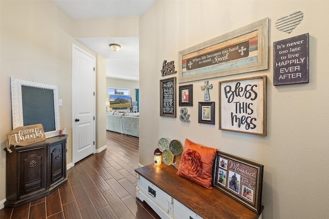 hallway with dark hardwood / wood-style flooring