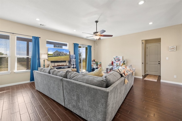 living room featuring ceiling fan and dark hardwood / wood-style flooring