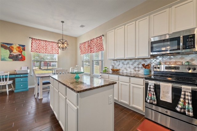 kitchen with stainless steel appliances, dark wood-type flooring, white cabinetry, and a center island