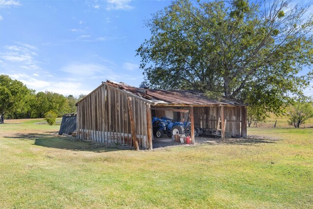 view of outdoor structure featuring a lawn