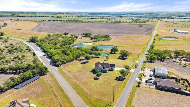 birds eye view of property with a water view and a rural view