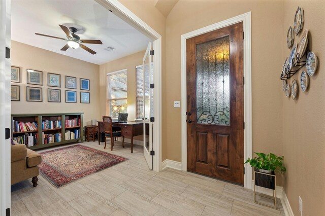 foyer entrance featuring ceiling fan