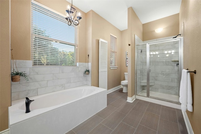 bathroom with plus walk in shower, an inviting chandelier, and toilet