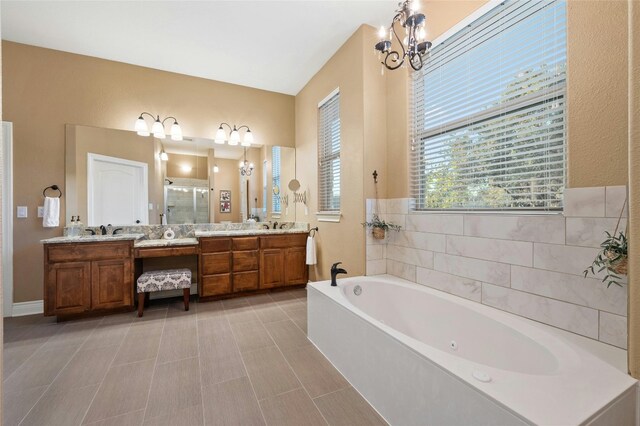 bathroom with an inviting chandelier, vanity, and plus walk in shower