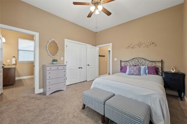 carpeted bedroom featuring ceiling fan and a closet