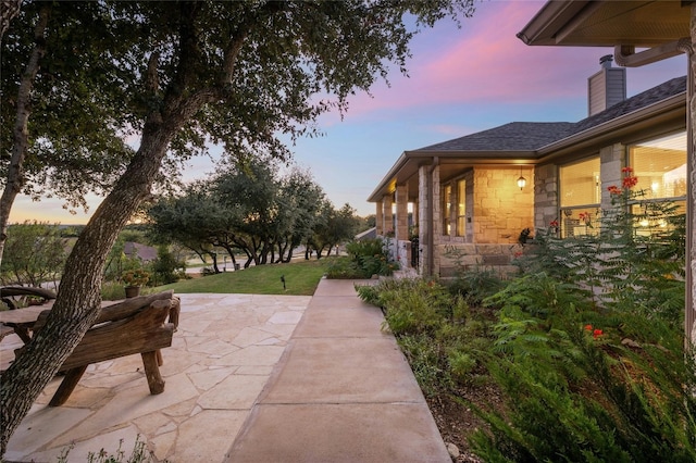 patio terrace at dusk with a lawn