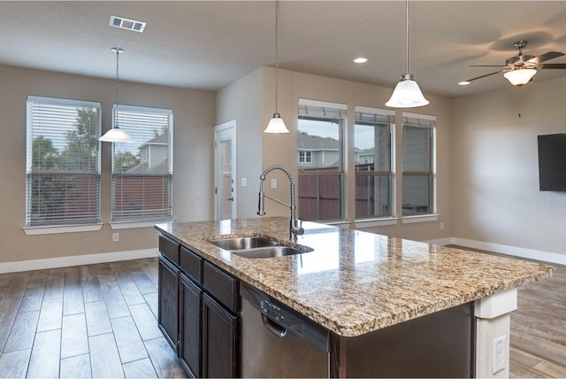 kitchen featuring a center island with sink, stainless steel dishwasher, sink, and plenty of natural light