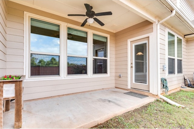 doorway to property featuring ceiling fan and a patio area