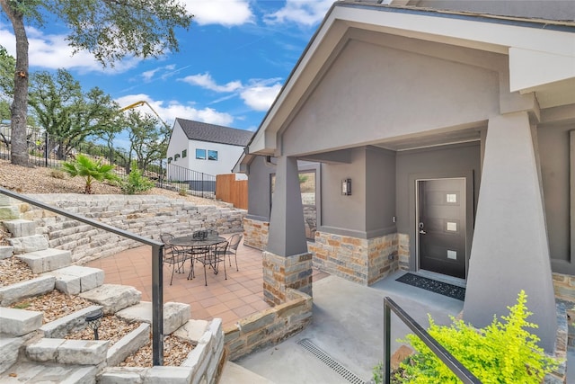 entrance to property with a patio