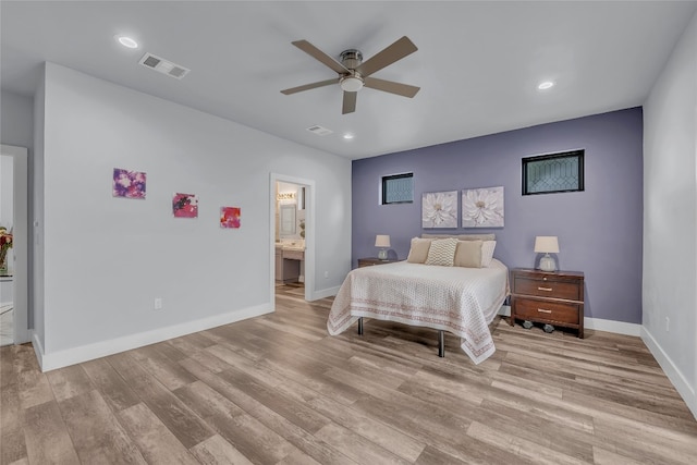 bedroom featuring ensuite bath, light hardwood / wood-style flooring, and ceiling fan