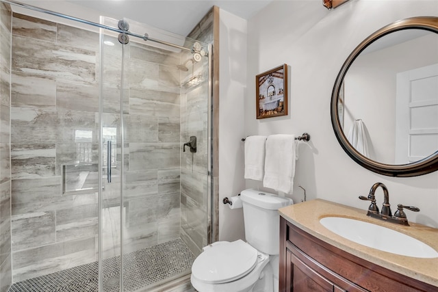 bathroom featuring walk in shower, vanity, and toilet