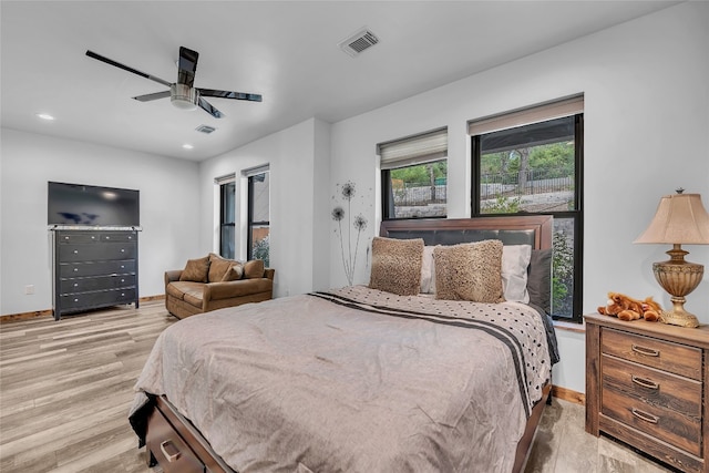 bedroom with ceiling fan and light hardwood / wood-style flooring