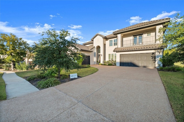 mediterranean / spanish house featuring a balcony, a garage, and a front lawn