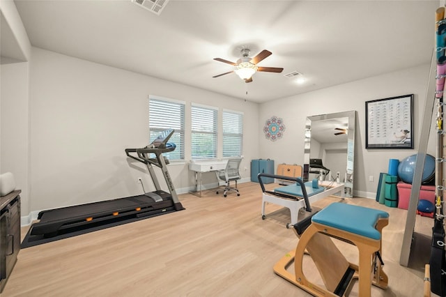 workout area featuring ceiling fan and hardwood / wood-style floors