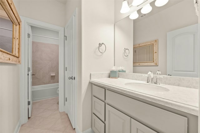 full bathroom with tile patterned floors, tiled shower / bath, vanity, and toilet