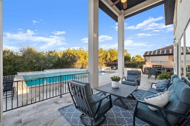 view of patio / terrace featuring a fenced in pool and an outdoor living space