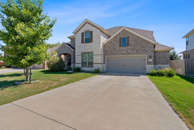 view of front of property with a garage and a front lawn