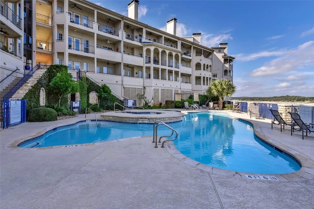 view of pool featuring a hot tub and a patio