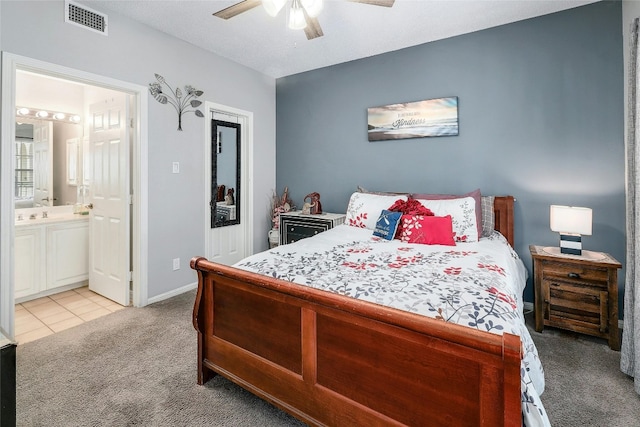 carpeted bedroom featuring connected bathroom and ceiling fan