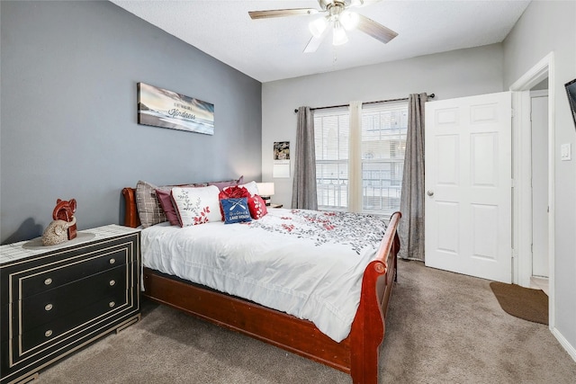 bedroom featuring ceiling fan and dark colored carpet