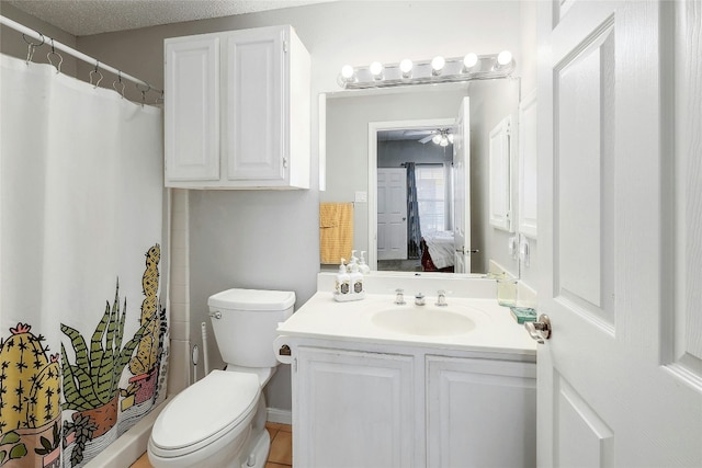 bathroom featuring ceiling fan, vanity, a textured ceiling, walk in shower, and toilet